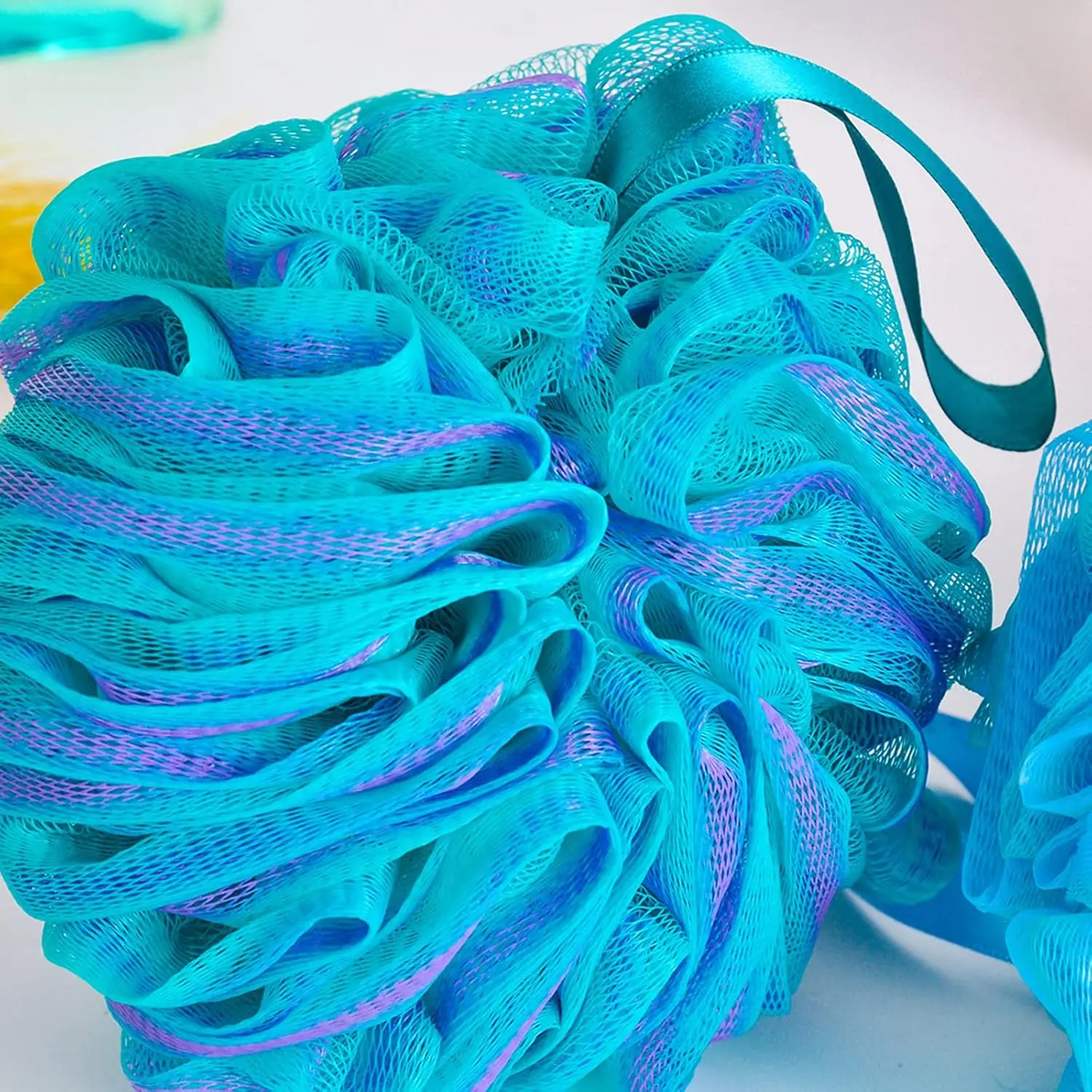 This set includes four colorful bath shower sponges designed with strong knotting for durability, creating a rich lather and gently exfoliating the skin.