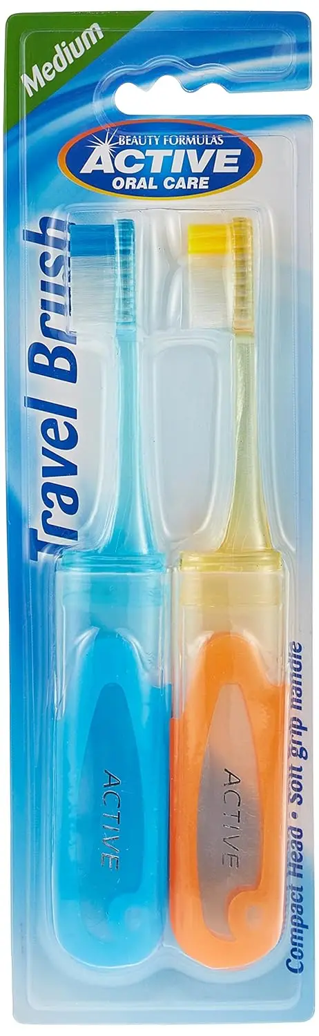 Two Beauty Formulas Active Oral Care travel toothbrushes with assorted colors, designed with round-ended filaments for gentle cleaning and a comfortable handle.