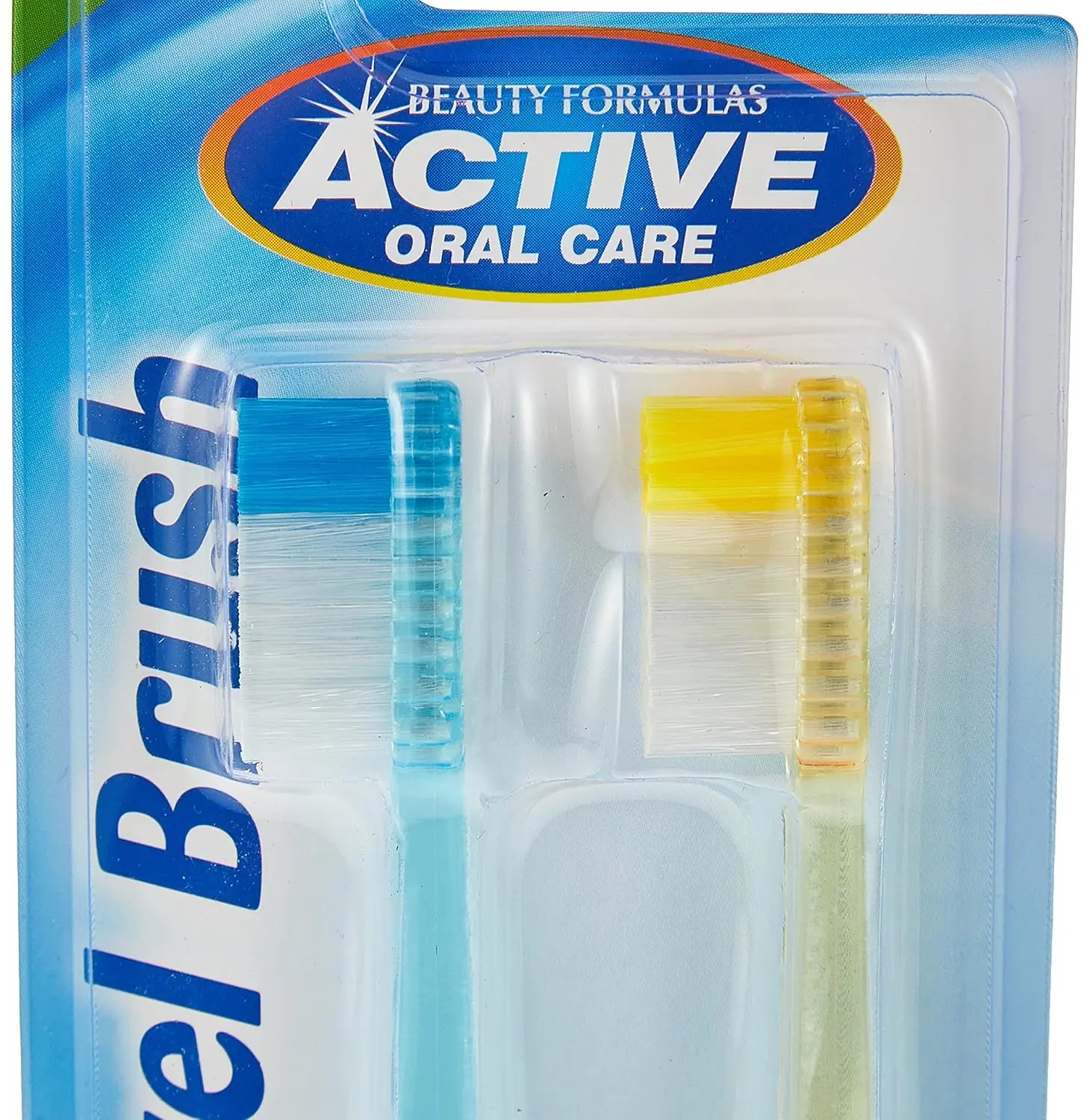 Two Beauty Formulas Active Oral Care travel toothbrushes with assorted colors, designed with round-ended filaments for gentle cleaning and a comfortable handle.