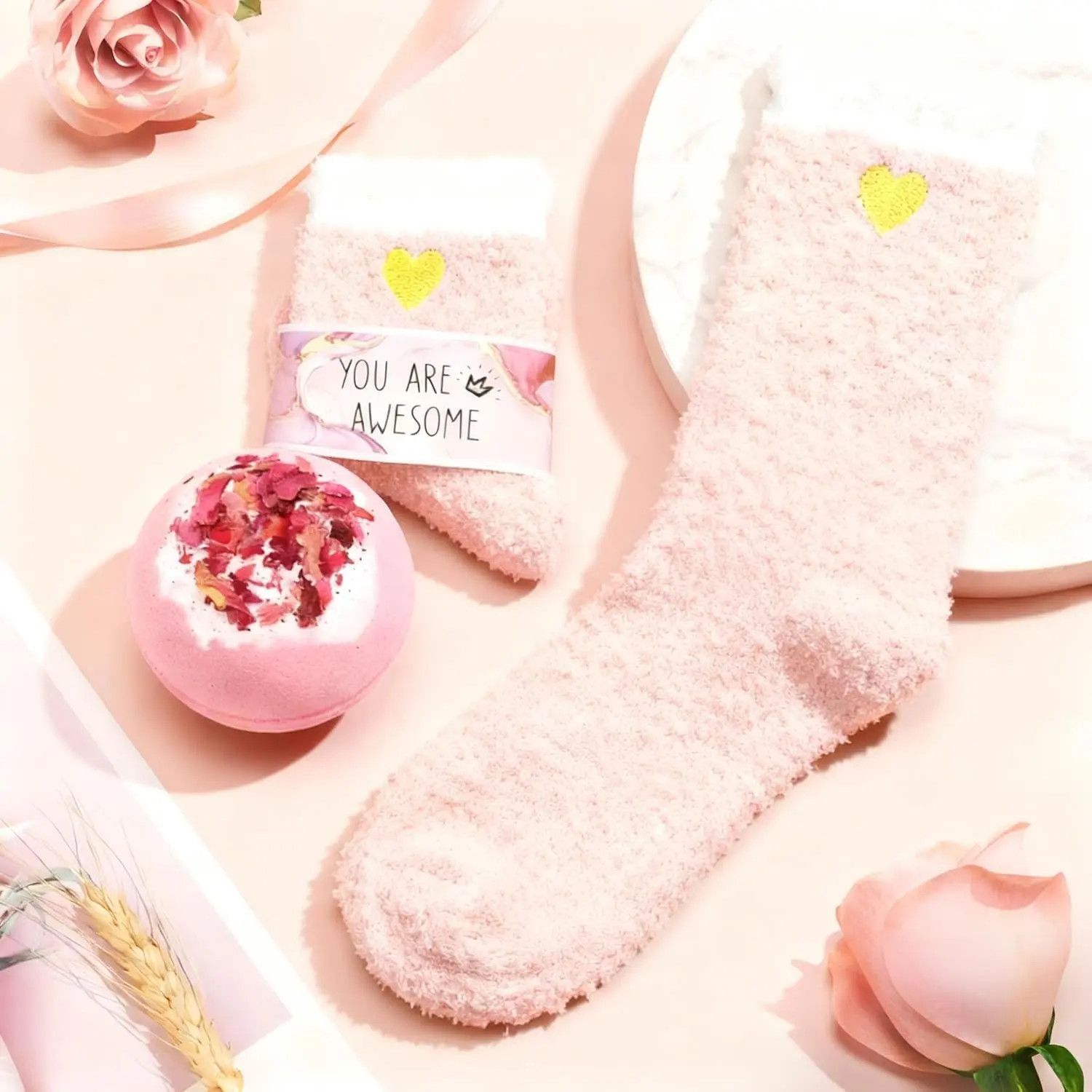 This 12-piece pink birthday gift set for women includes a marble mug, bath bomb, scented candle, makeup bag, jewelry, and more self-care items for a relaxing spa experience.