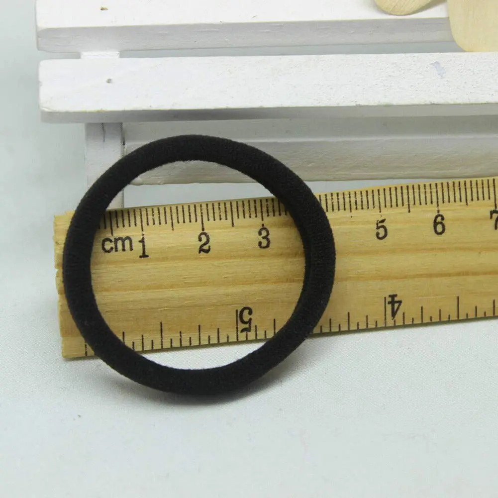 A bulk pack of 100 black seamless hair ties perfect for thick, curly, straight, or thin hair, suitable for toddlers, girls, and kids.