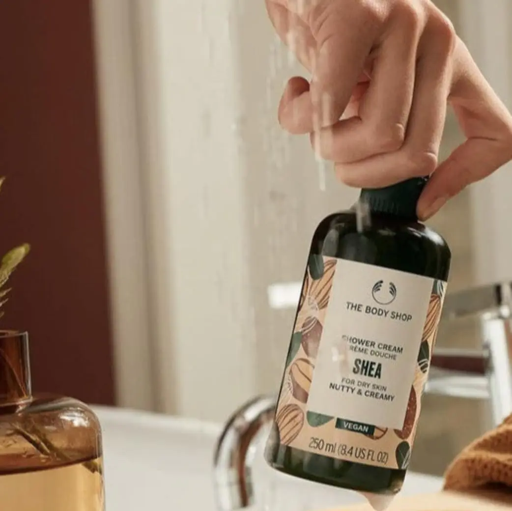 The Body Shop Shea Gift Set includes Shea Shower Cream, Body Butter, Hand Balm, Soap, and a Ramie Bath Flower for cleansing, nourishing, and pampering dry skin.