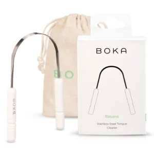 This stainless steel Boka tongue scraper effectively removes buildup, promoting fresh breath and healthier taste buds with its ergonomic design, and comes with a linen travel pouch.