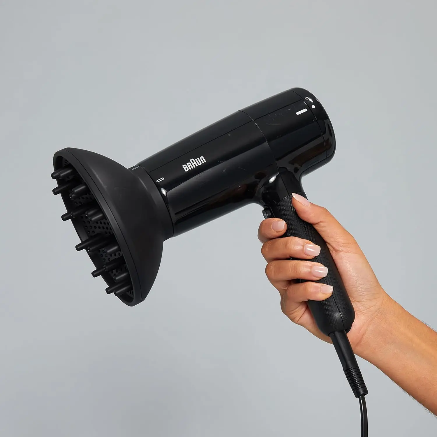 The Braun HD2.2 hair dryer in ion black, featuring 2200 watts of power, IONTEC technology for shine, and three heat modes for fast and customizable drying.