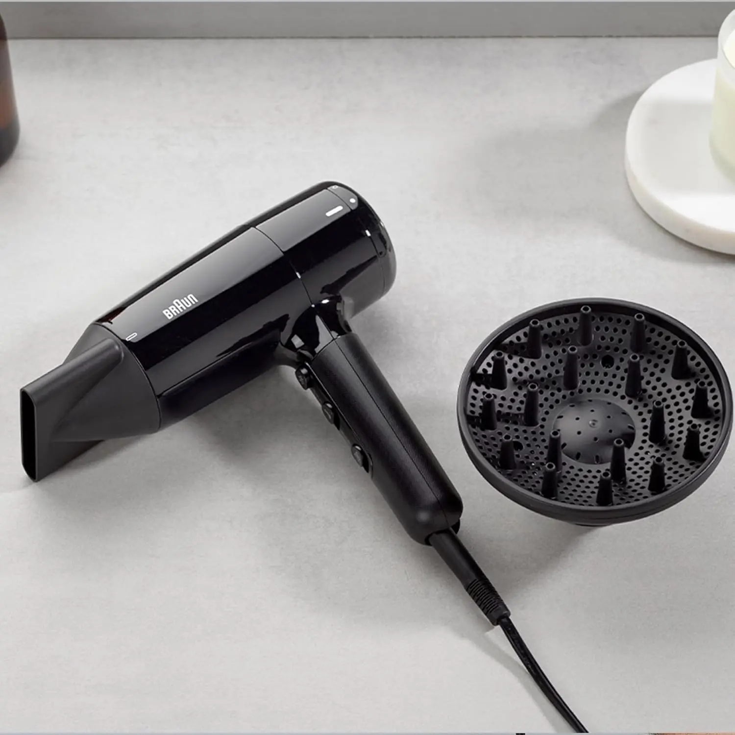 The Braun HD2.2 hair dryer in ion black, featuring 2200 watts of power, IONTEC technology for shine, and three heat modes for fast and customizable drying.