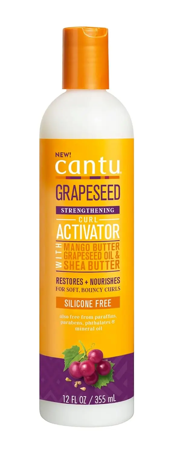 Cantu Grapeseed Curl Activator Cream hydrates and defines curls with shea butter, grapeseed, olive oil, aloe, and mango seed butter, leaving hair soft and moisturized in all climates.