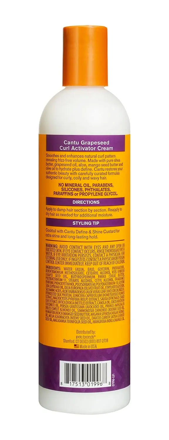 Cantu Grapeseed Curl Activator Cream hydrates and defines curls with shea butter, grapeseed, olive oil, aloe, and mango seed butter, leaving hair soft and moisturized in all climates.