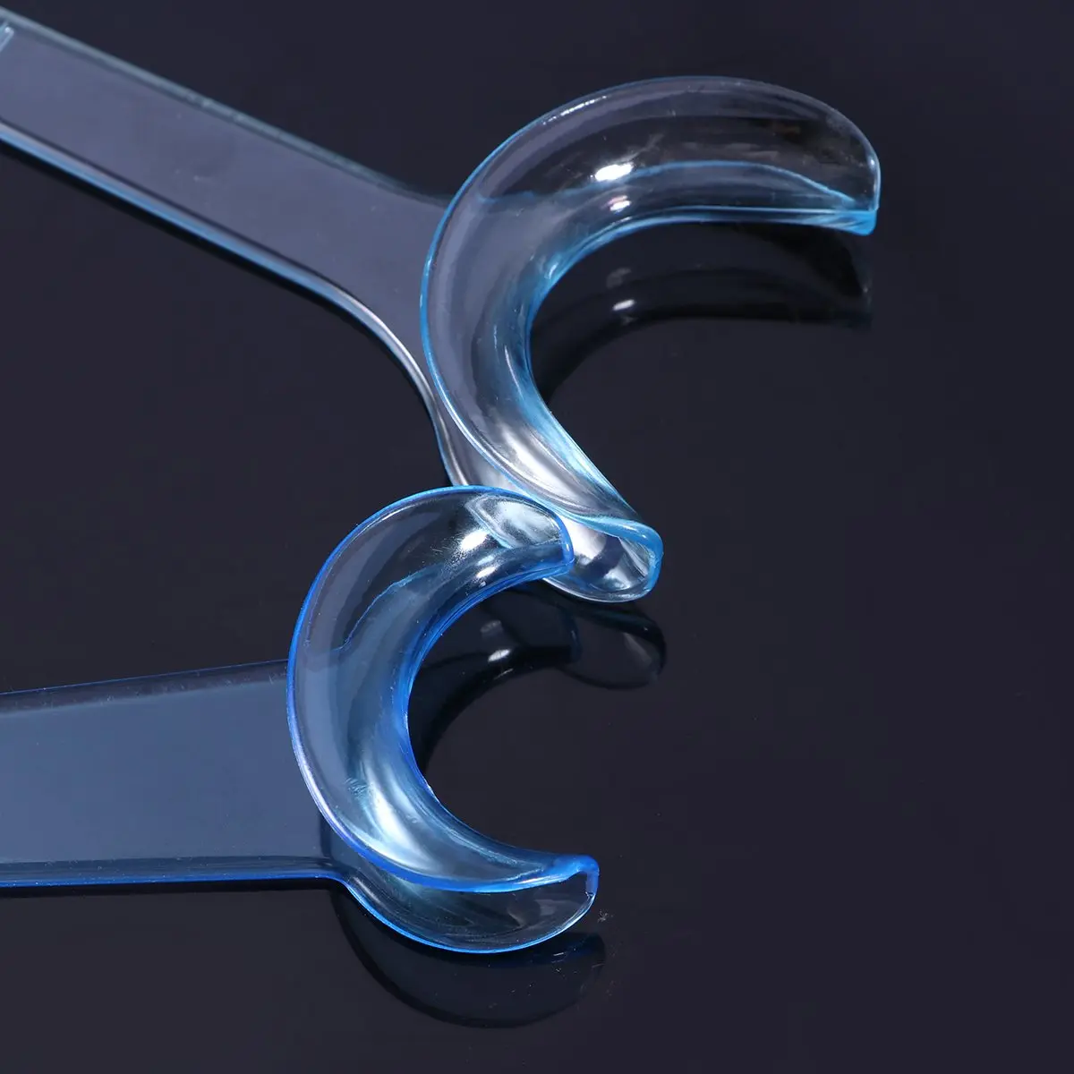 Eight blue T-shaped plastic cheek retractors and mouth openers for clear teeth whitening in dental and orthodontic practices, designed for sterilization and extended use.
