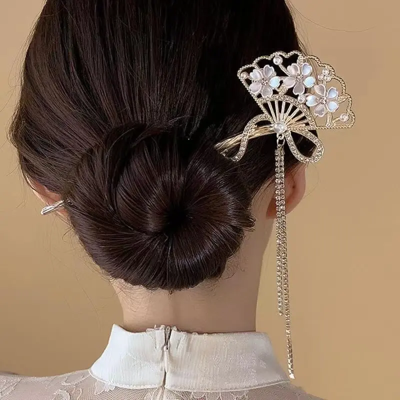 Four elegant floral Chinese hair sticks offer a vintage and stylish way to accessorize long hair.