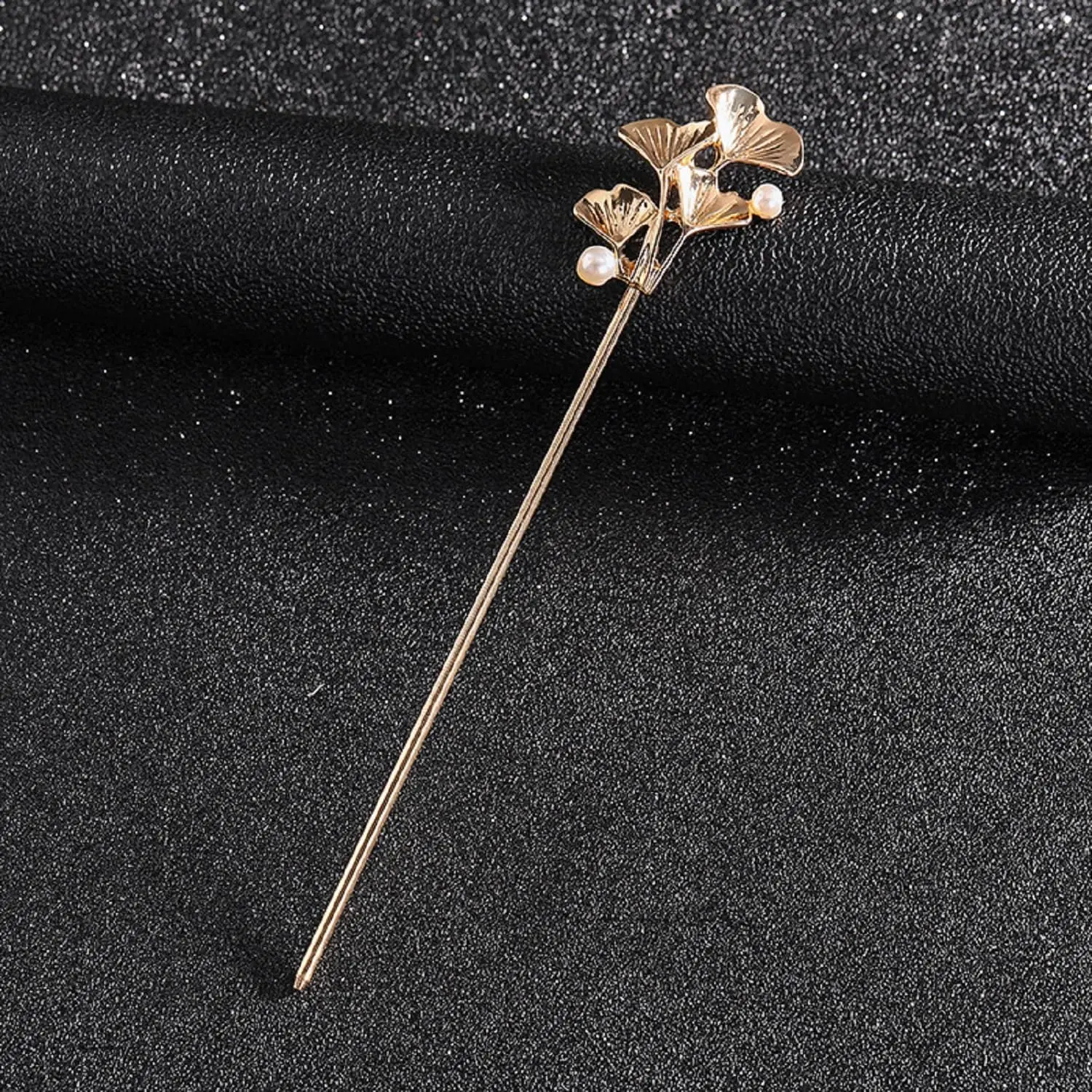 Four elegant floral Chinese hair sticks offer a vintage and stylish way to accessorize long hair.