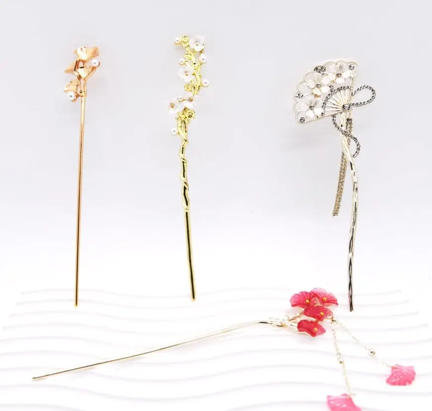 Four elegant floral Chinese hair sticks offer a vintage and stylish way to accessorize long hair.