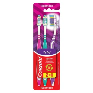 A three-pack of Colgate Zigzag medium toothbrushes featuring V-shaped bristles for cleaning between teeth and a raised tip for reaching back molars.