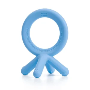 The Comotomo blue silicone baby teether features four prongs mimicking baby fingers, designed for easy grabbing and safe chewing during teething.