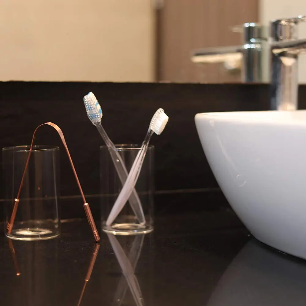This high-quality copper tongue cleaner with stainless steel comfort grip handles gently removes bacteria and plaque for improved oral hygiene and fresh breath.