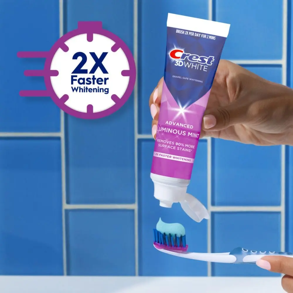 Four tubes of Crest 3D White Advanced Luminous Mint toothpaste for teeth whitening and cavity protection.