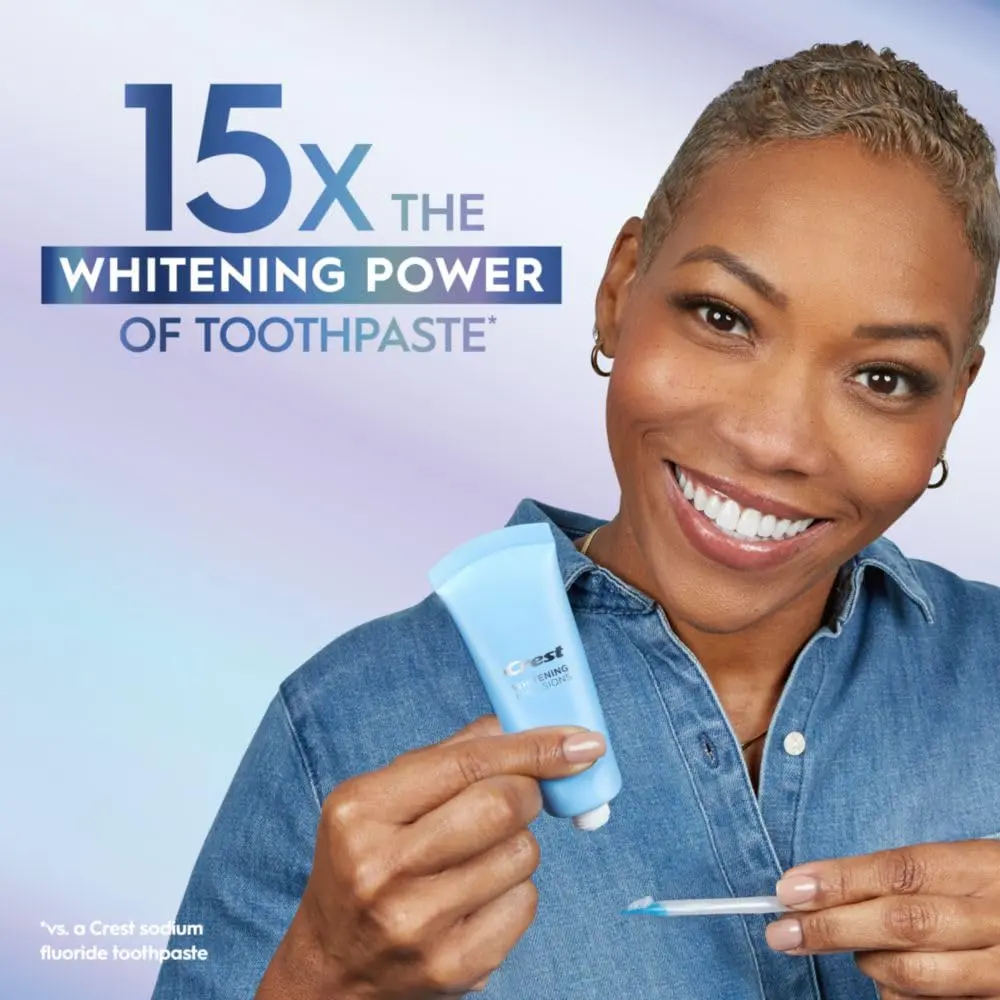 The Crest Whitening Emulsions kit includes a tube of whitening gel, a wand applicator, and a stand for easy storage, designed to whiten teeth and freshen breath while you sleep.