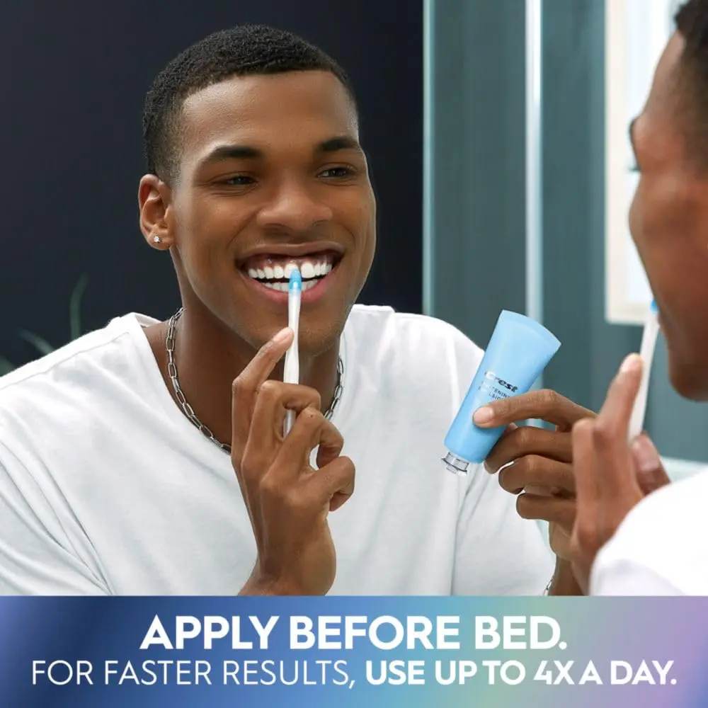 The Crest Whitening Emulsions kit includes a tube of whitening gel, a wand applicator, and a stand for easy storage, designed to whiten teeth and freshen breath while you sleep.