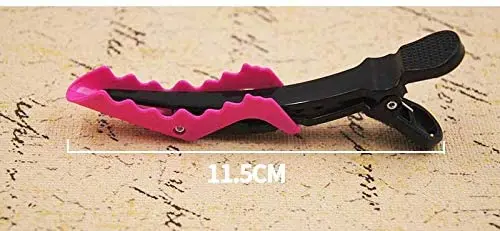 A plastic crocodile shaped hair clip, used for styling and sectioning hair.