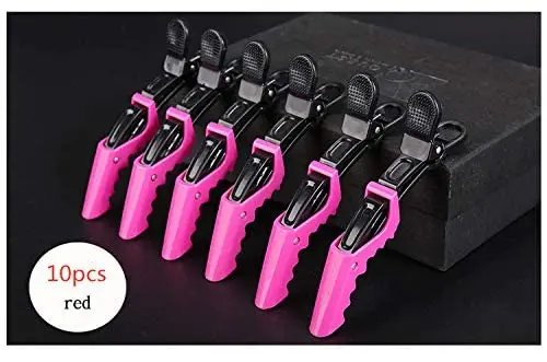 A plastic crocodile shaped hair clip, used for styling and sectioning hair.