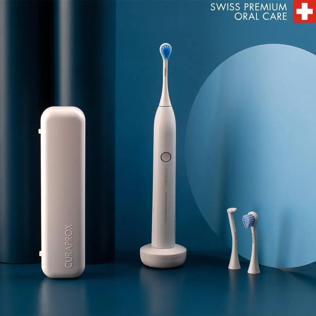 The Curaprox Hydrosonic Pro electric toothbrush provides customized oral care with 7 cleaning levels and comes with multiple brush heads, a travel case, and charging accessories.