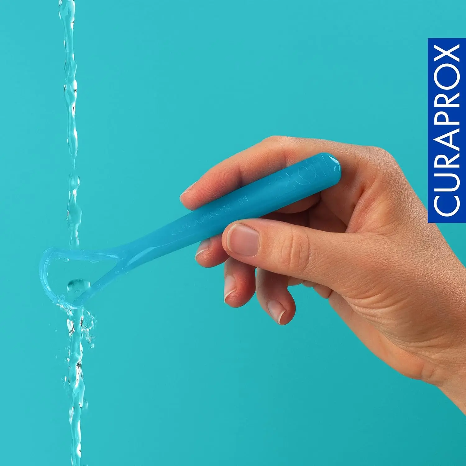 The Curaprox double-bladed tongue cleaner gently removes bacteria for fresher breath and improved oral hygiene, featuring a comfortable and durable Swiss-made design.