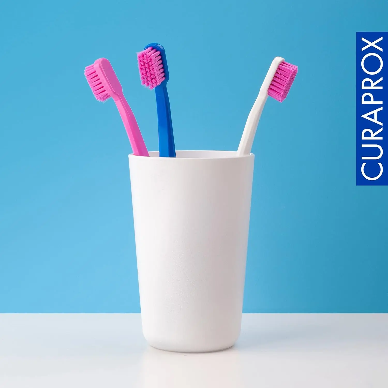 This image shows a six-pack of Curaprox CS 5460 ultra-soft toothbrushes with densely packed CUREN bristles for gentle and effective plaque removal and gum line cleaning.