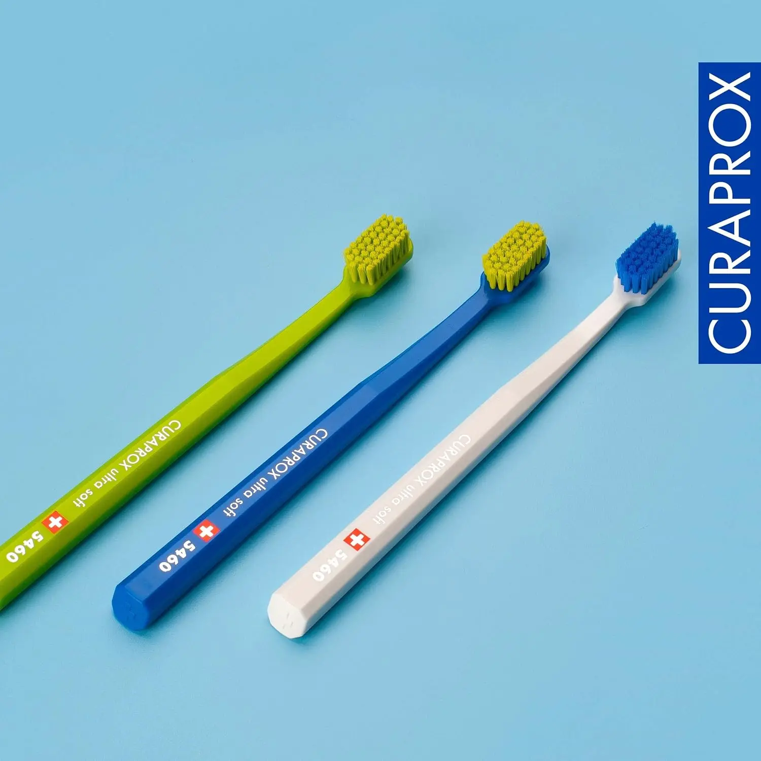 This image shows a 3-pack of Curaprox CS 5460 ultra-soft toothbrushes designed for adults, featuring 5460 CUREN bristles for gentle yet effective plaque removal, ideal for sensitive gums.
