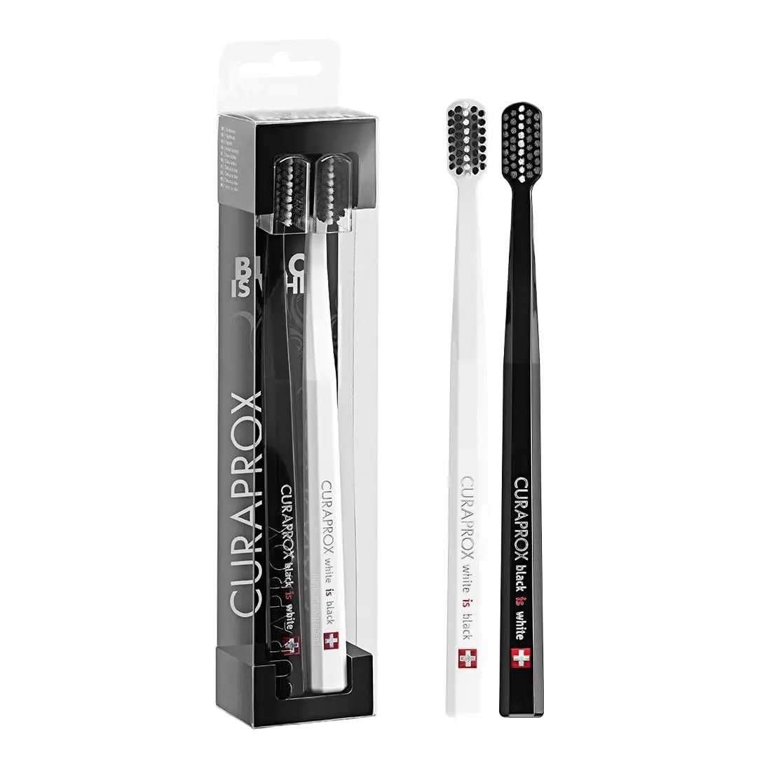 This pack contains two black and white Curaprox ultra-soft toothbrushes with 8,760 CUREN filaments for gentle yet effective plaque removal, ideal for sensitive teeth and gums.