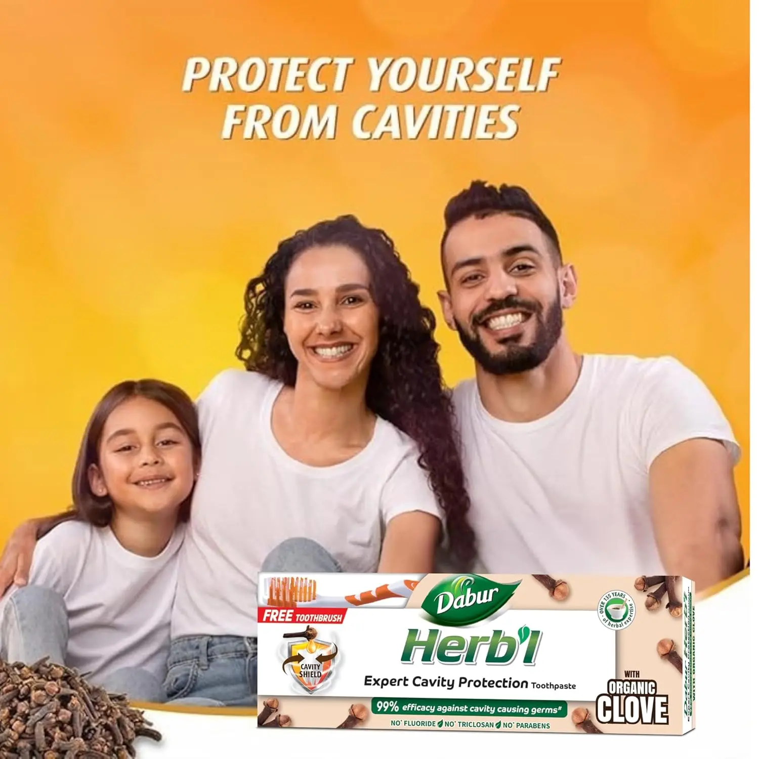 Dabur Herbal Clove toothpaste protects against cavities with natural ingredients and provides relief from toothache, shown with a bonus toothbrush.