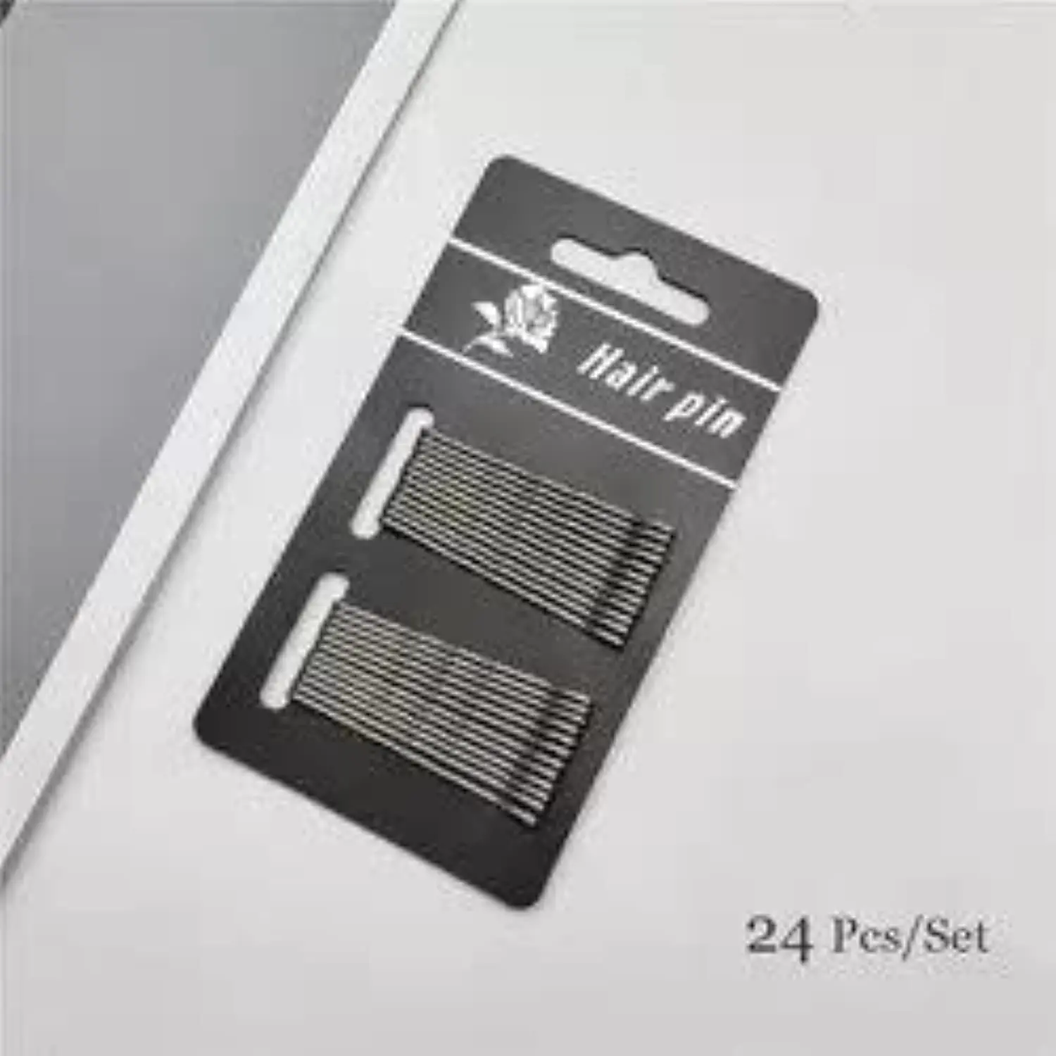 A set of dark grey hair pins provides a secure, non-slip grip for creating elegant updos and various hairstyles on both thick and thin hair.