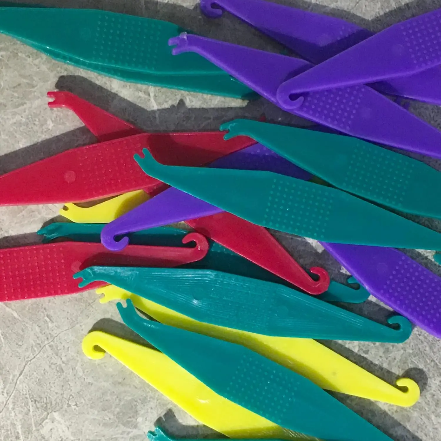 This pack of 20 multi-colored dental elastic placers are disposable tools designed to easily apply and remove rubber bands on braces, making orthodontic treatment more convenient.