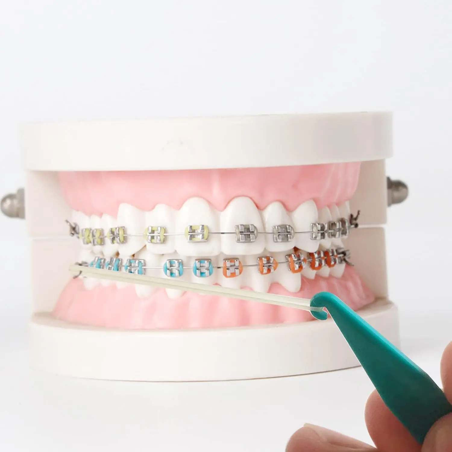 This pack of 20 multi-colored dental elastic placers are disposable tools designed to easily apply and remove rubber bands on braces, making orthodontic treatment more convenient.