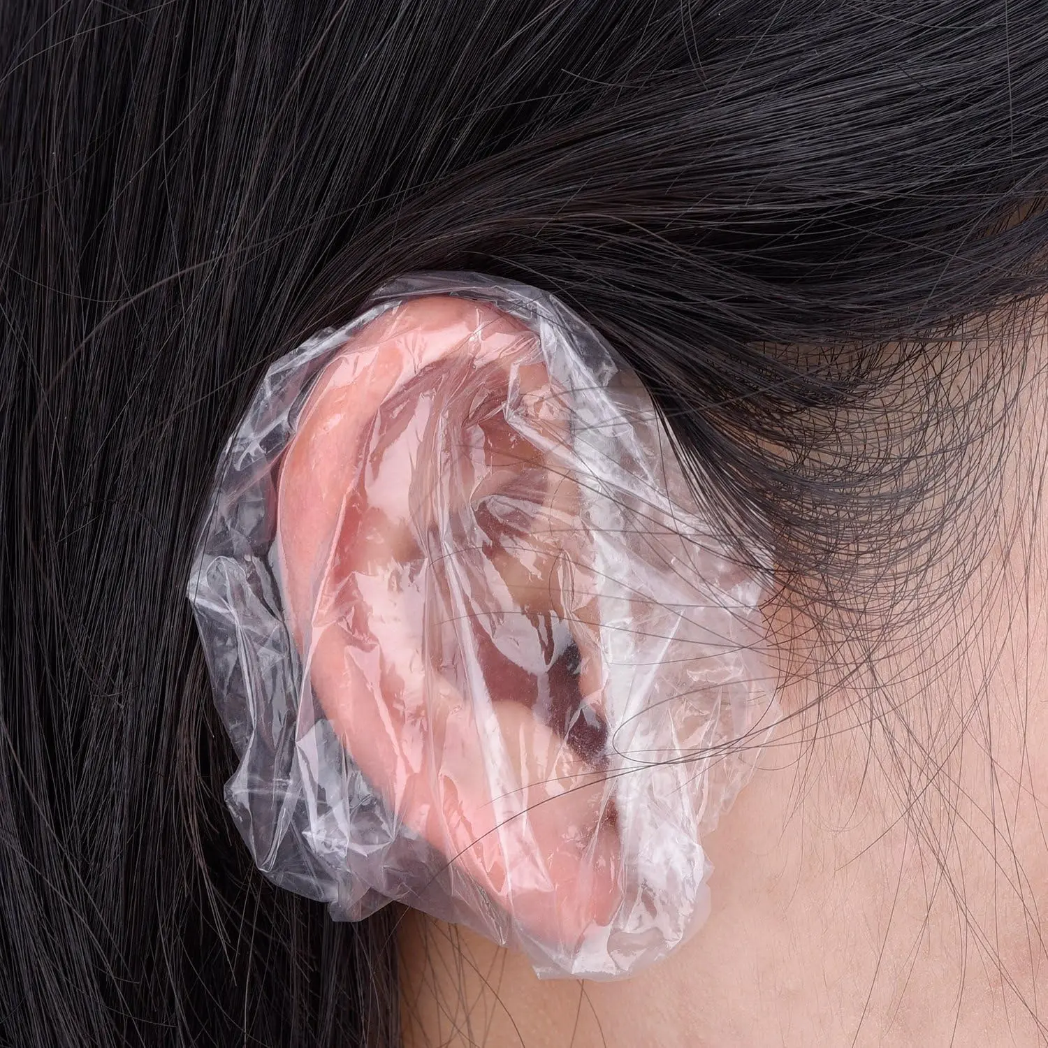 Two hundred clear disposable ear covers made of waterproof PE material, ideal for protecting ears during showers, hair dyeing, and salon treatments.