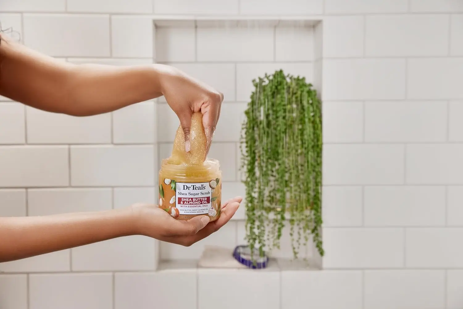 A jar of Dr Teal's Shea Sugar Body Scrub with shea butter and almond oil for exfoliating and smoothing skin.