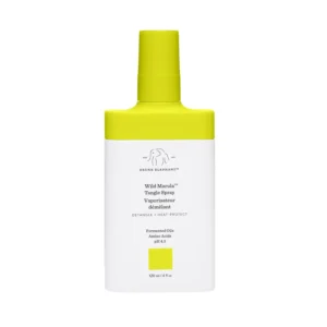 A bottle of Drunk Elephant Wild Marula Tangle Spray, a weightless leave-in mist that detangles hair, provides heat protection, and restores shine without silicones.