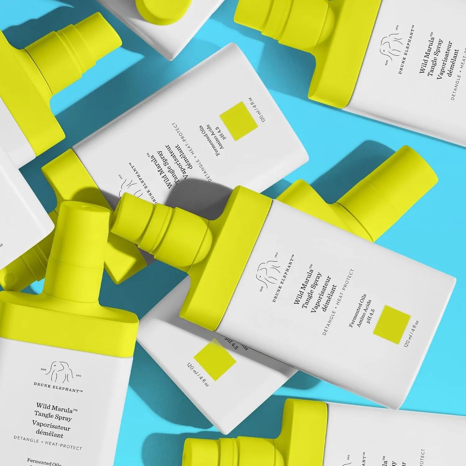 A bottle of Drunk Elephant Wild Marula Tangle Spray, a weightless leave-in mist that detangles hair, provides heat protection, and restores shine without silicones.