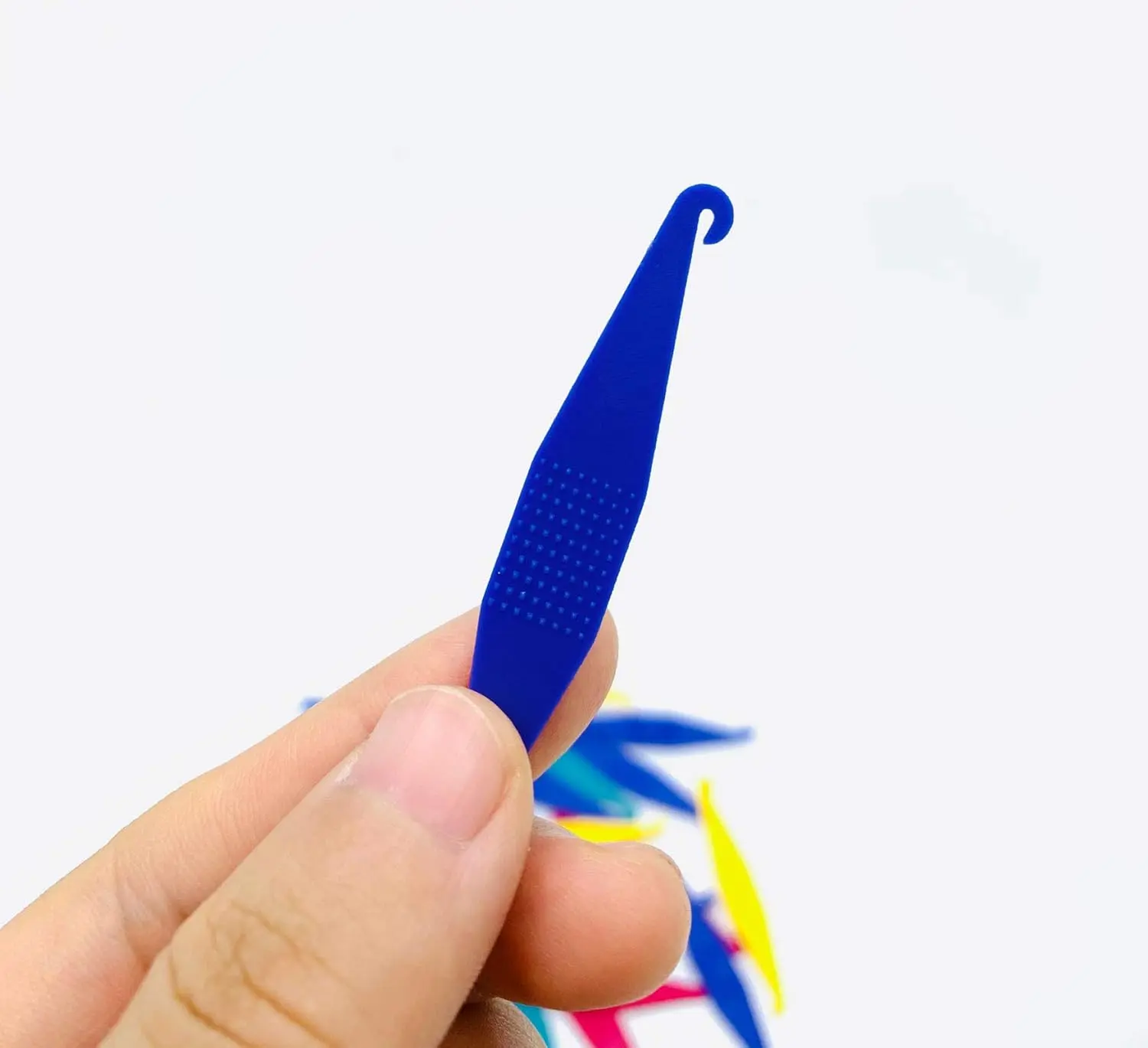 This image shows multi-colored disposable plastic orthodontic elastic placers designed to easily fit and remove rubber bands on braces.