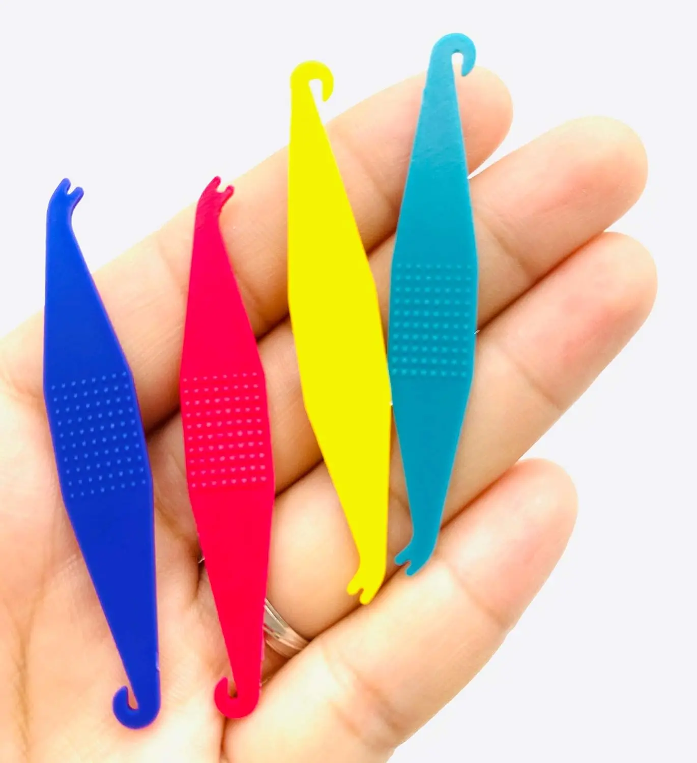 This image shows multi-colored disposable plastic orthodontic elastic placers designed to easily fit and remove rubber bands on braces.