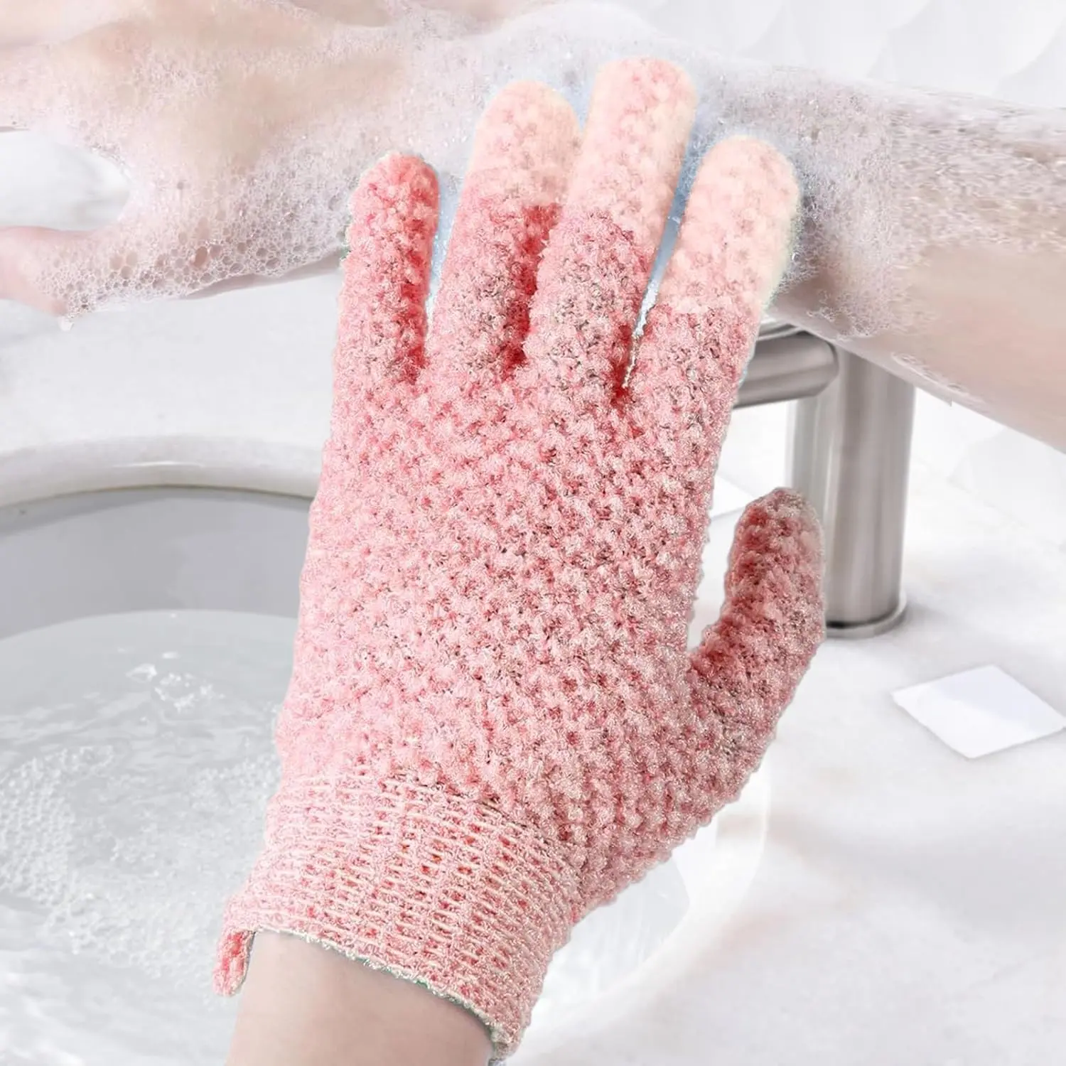 A pair of green exfoliating gloves for shower and body scrubs, with a hanging loop.