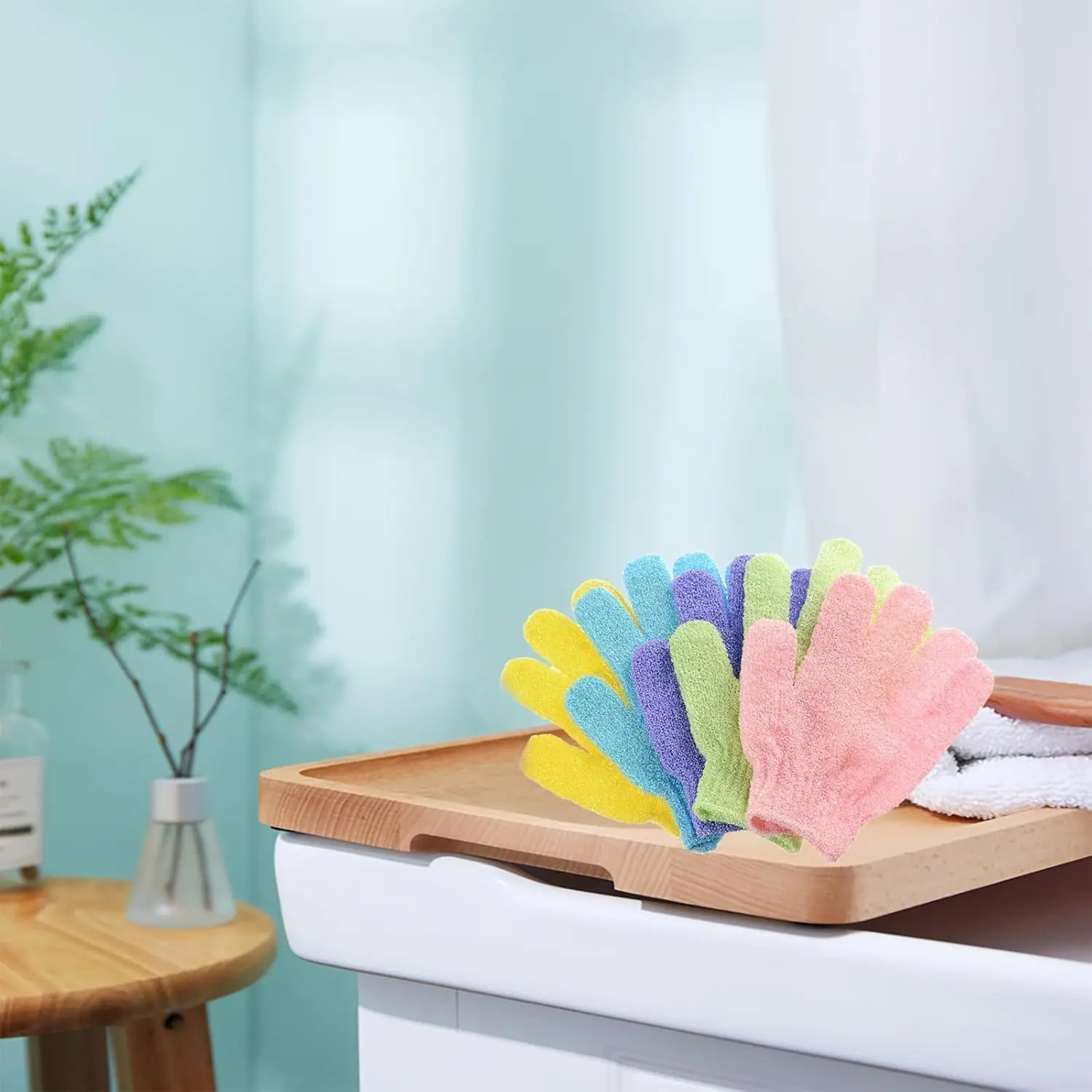 Pink and blue exfoliating bath gloves and sponges for deep cleansing and removing dead skin are displayed in this product image.