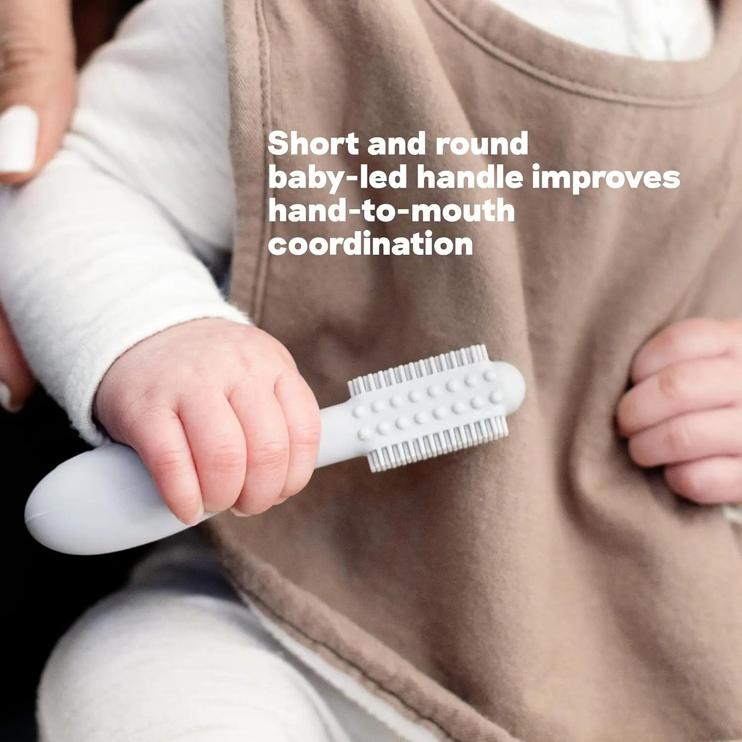 Sage-colored silicone baby toothbrush designed for infants 3+ months with an easy-grip handle and sensory bumps for early oral care.