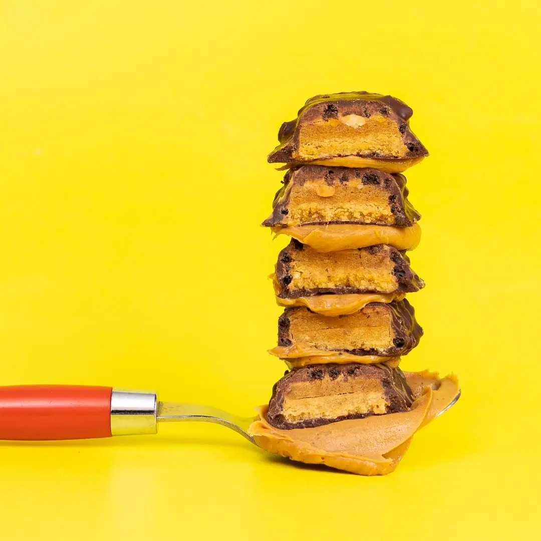 Twelve FITCRUNCH peanut butter flavored protein bars with 30g of protein and only 6g of sugar in a box.