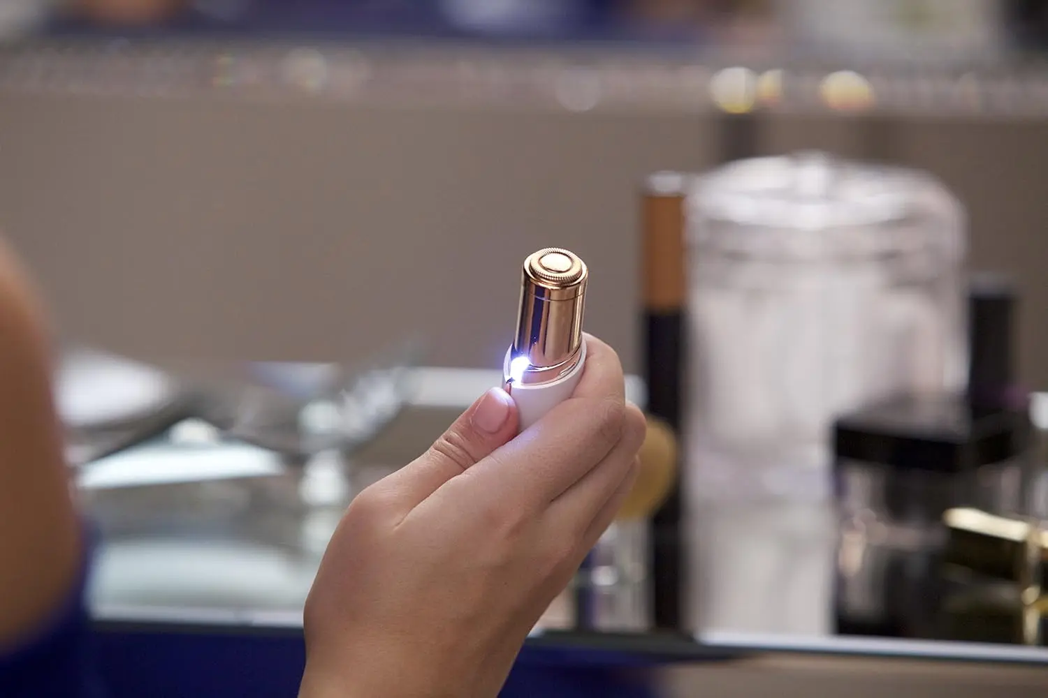 Rose gold, 18k gold-plated women's hair remover gently and painlessly removes facial hair and peach fuzz for flawless makeup application.