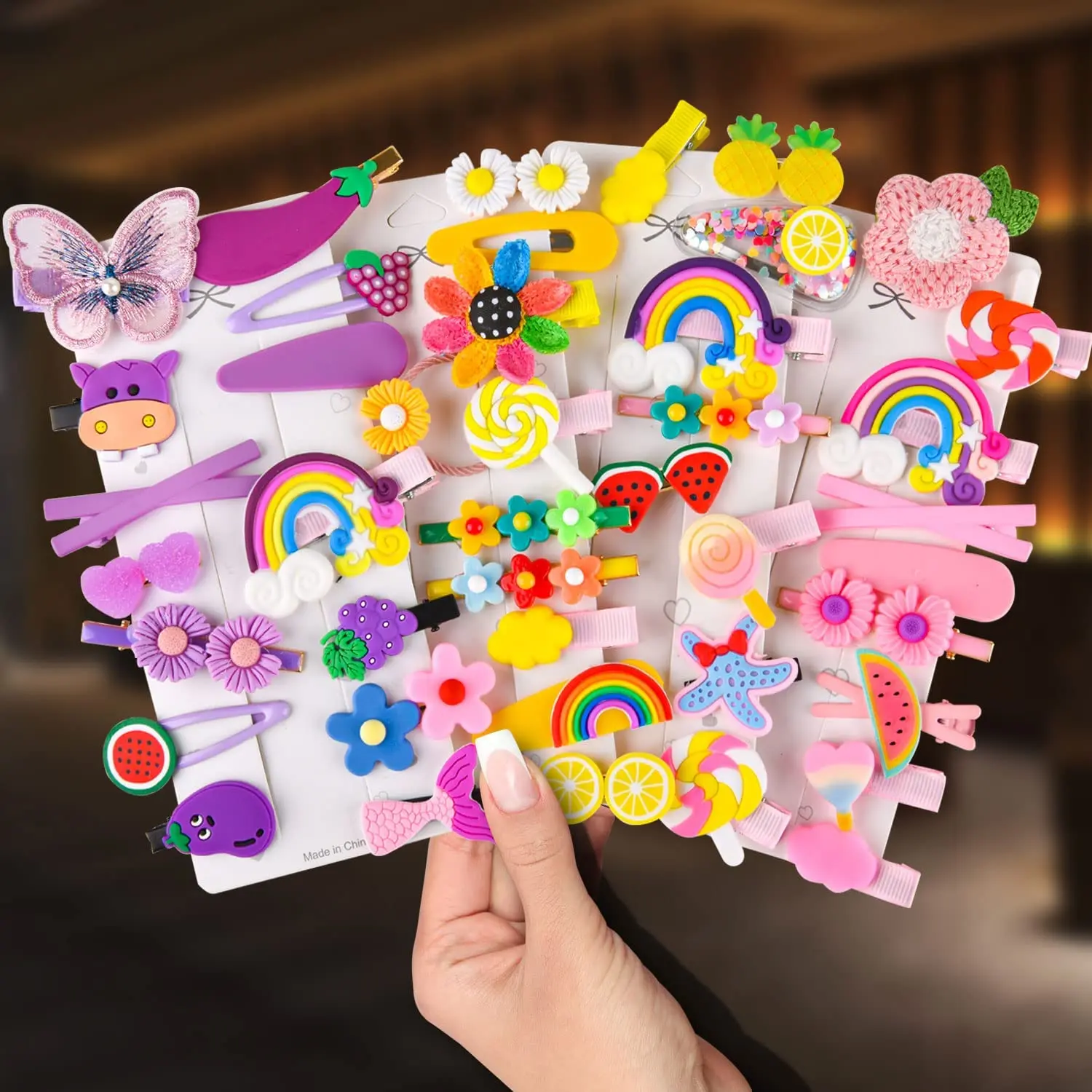 This set of 42 cute hair clips for girls includes various colorful designs such as butterflies, flowers, rainbows, fruits, and animals, perfect for styling baby and toddler hair.