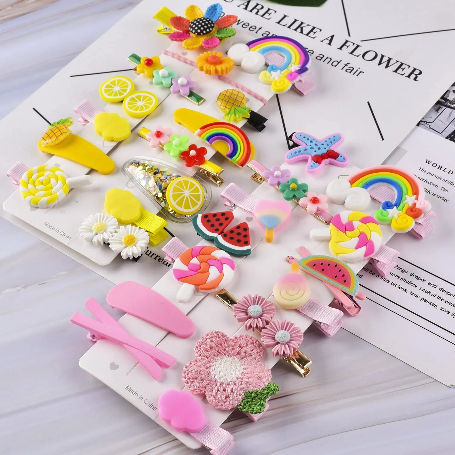 This set of 42 cute hair clips for girls includes various colorful designs such as butterflies, flowers, rainbows, fruits, and animals, perfect for styling baby and toddler hair.