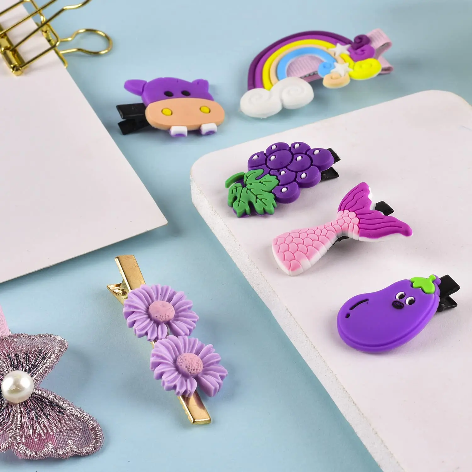 This set of 42 cute hair clips for girls includes various colorful designs such as butterflies, flowers, rainbows, fruits, and animals, perfect for styling baby and toddler hair.