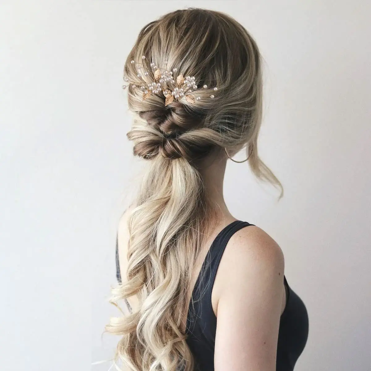 This image shows seven gold leaf wedding hair pins with pearls and crystals, elegant hair accessories for brides and bridesmaids to style their hair.