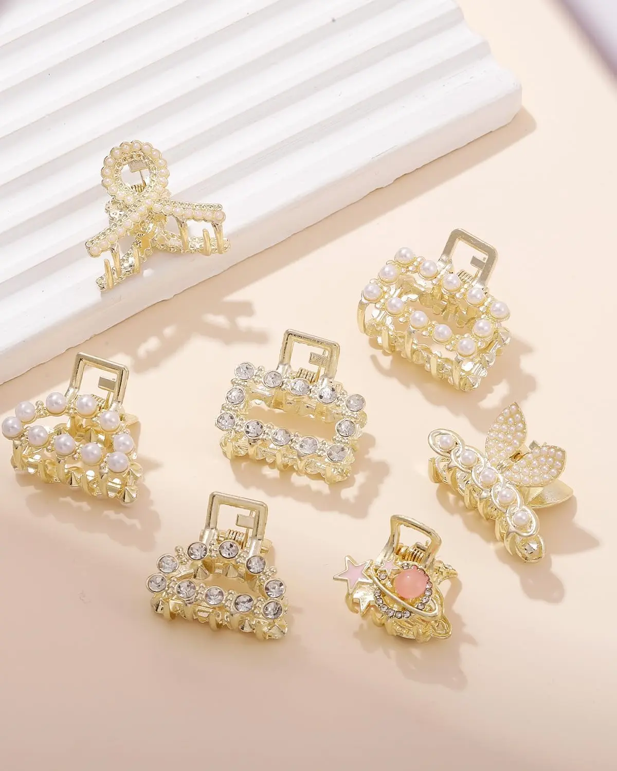This image displays a set of seven gold metal hair clips accented with pearls, designed for women's hair styling and fashion.