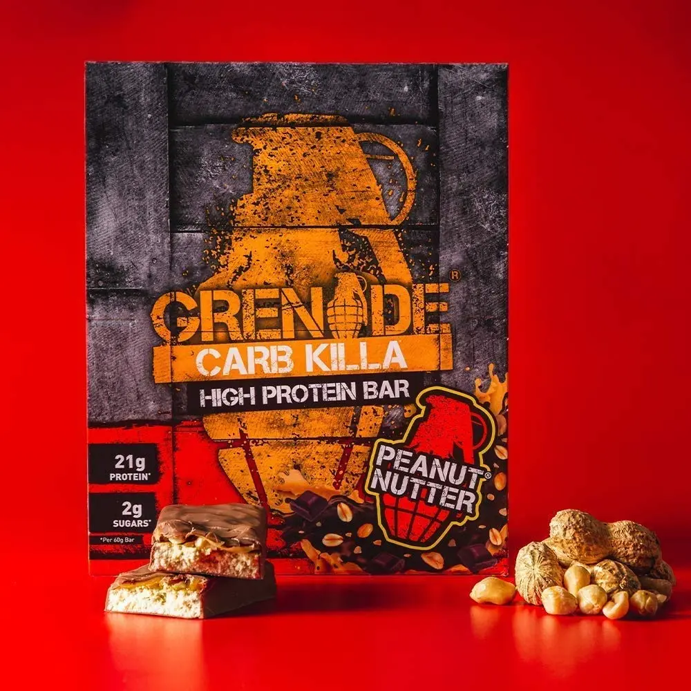 Twelve 60-gram Grenade Carb Killa Peanut Nutter protein bars, a unisex food supplement for active lifestyles.