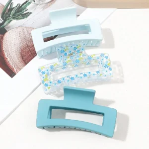 Three square hair claw clips in different colors securely holding thick hair for women.